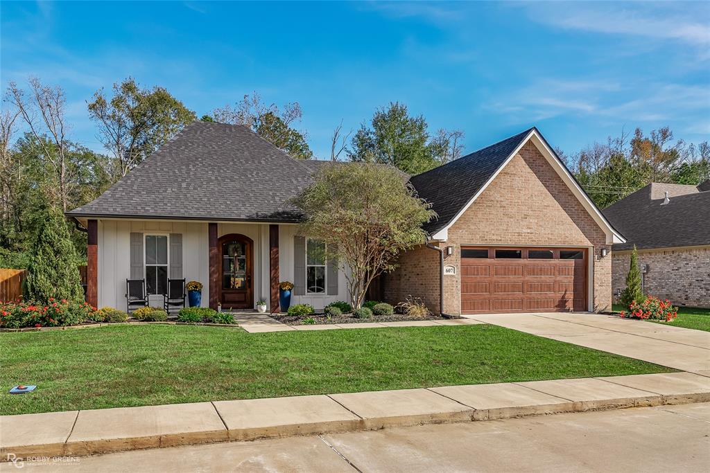 a front view of a house with a yard and garage