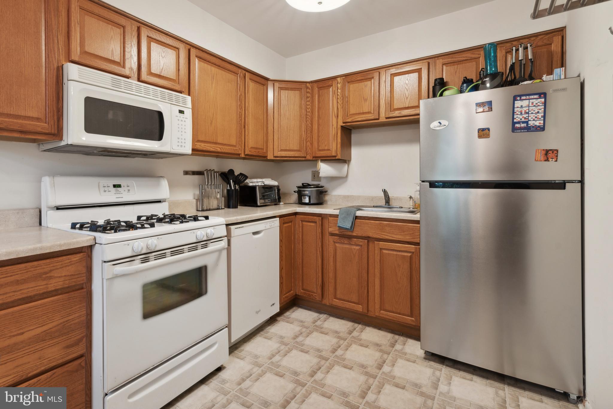 a white refrigerator freezer sitting in a kitchen