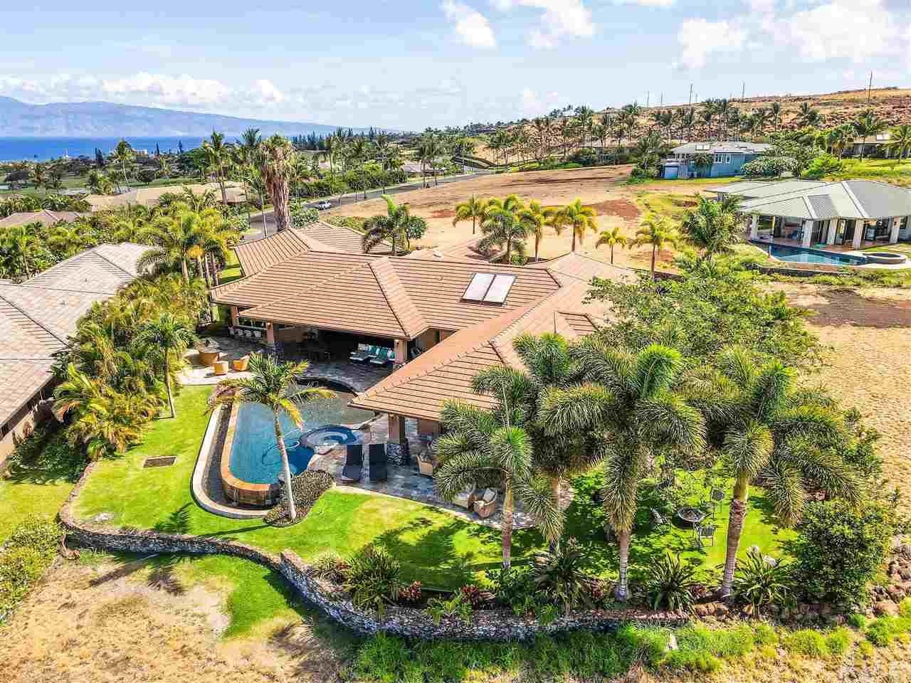 an aerial view of residential houses with outdoor space and lake view