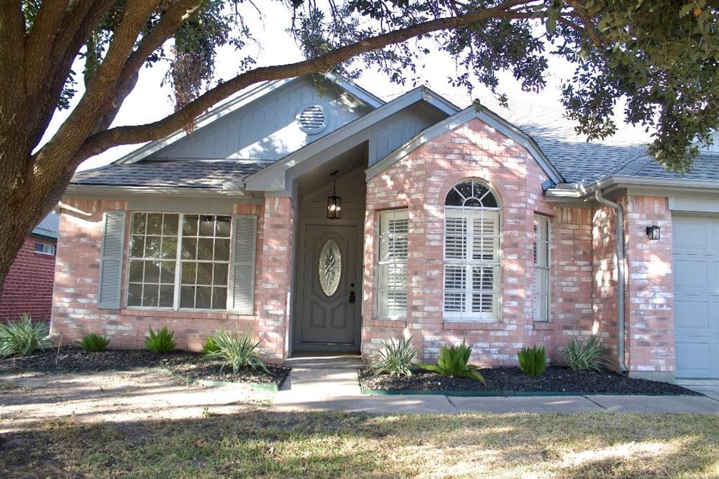 a front view of a house with a yard and outdoor seating