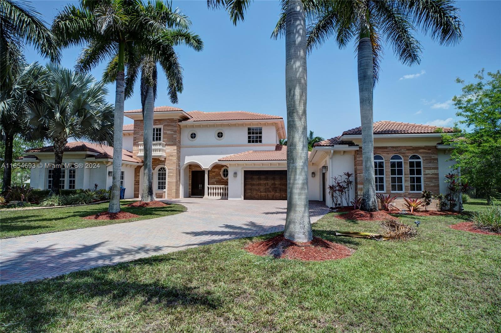 a front view of a house with yard and tree s