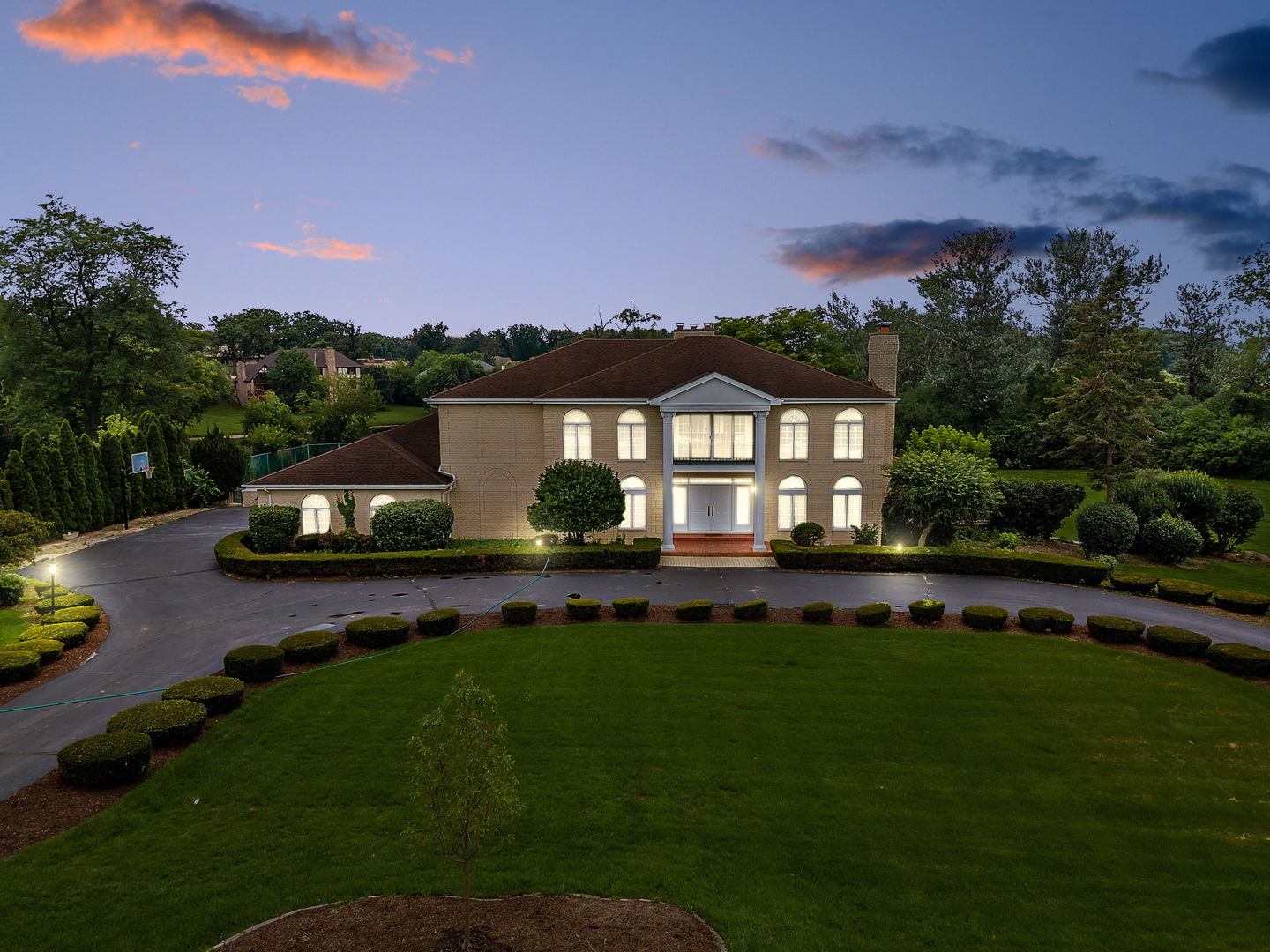 a front view of a house with a garden and yard