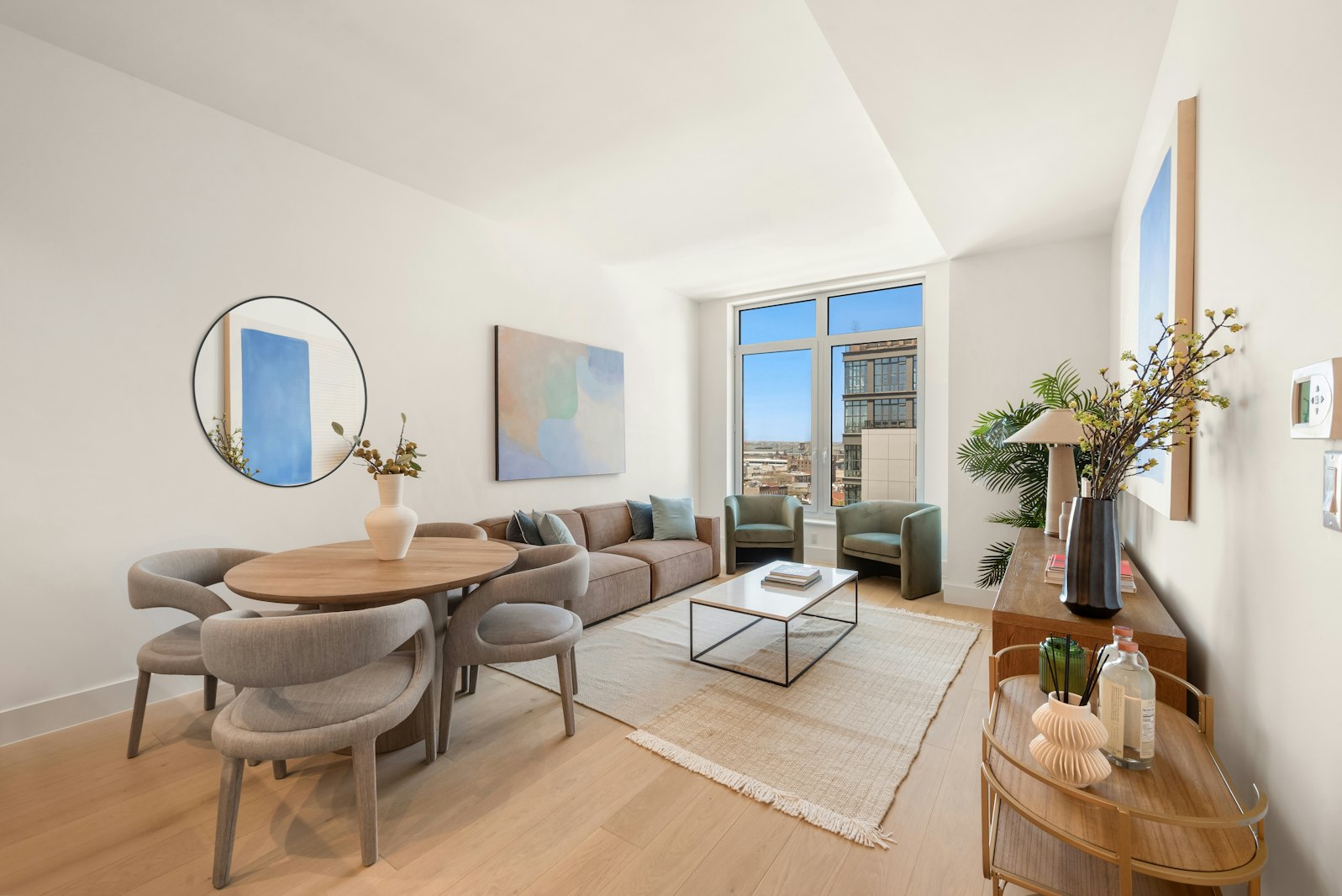 a living room with furniture a mirror and a potted plant