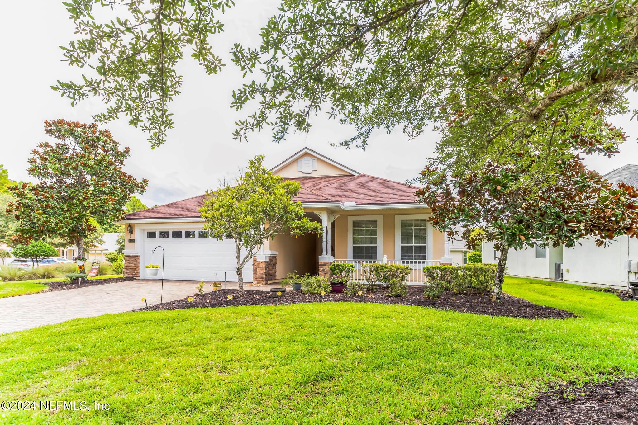 a front view of house with yard and green space