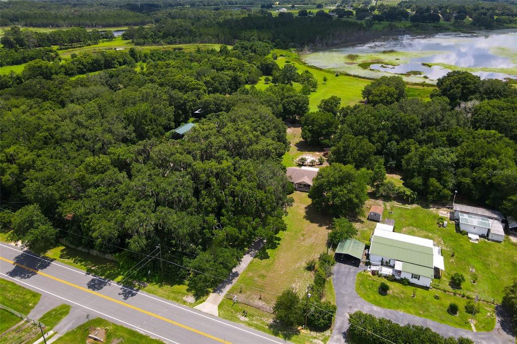 an aerial view of lake residential house with swimming pool and outdoor space