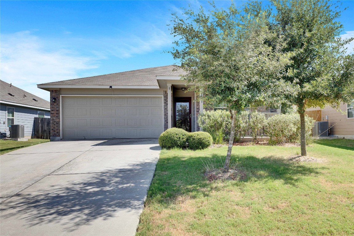 a view of a house with a yard and garage