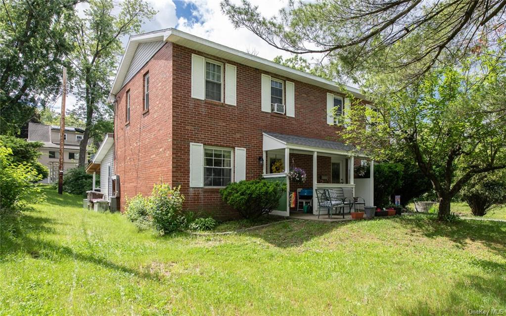 a front view of a house with yard and green space