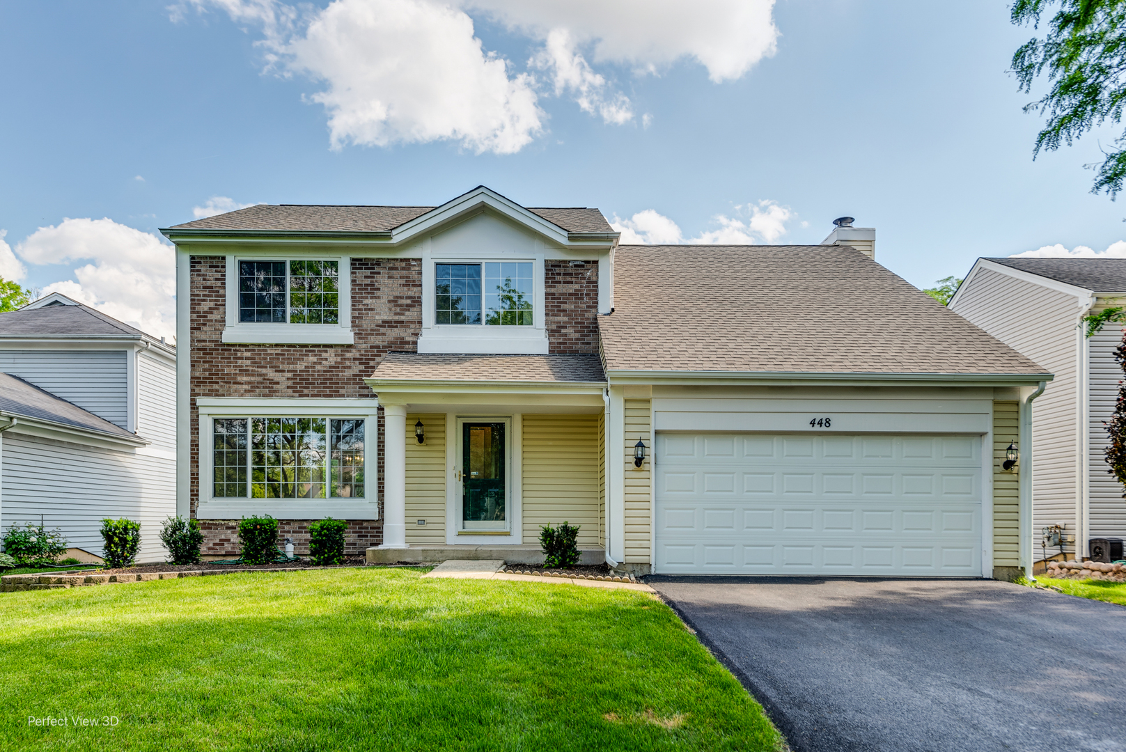 a front view of a house with a yard and garage