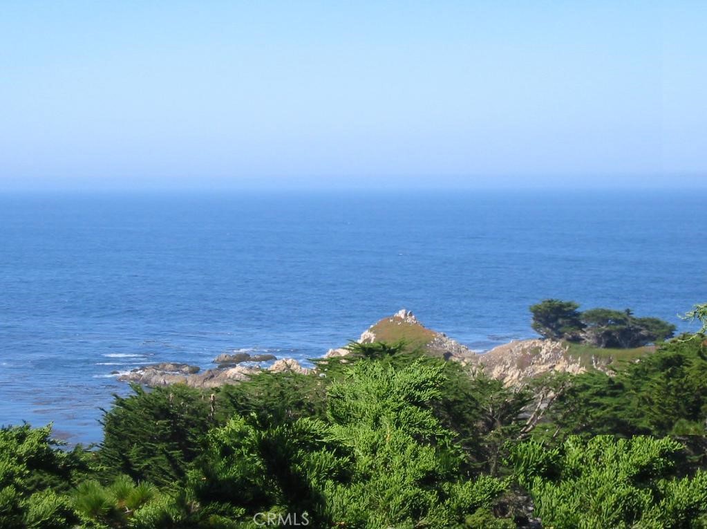 an aerial view of a ocean with beach