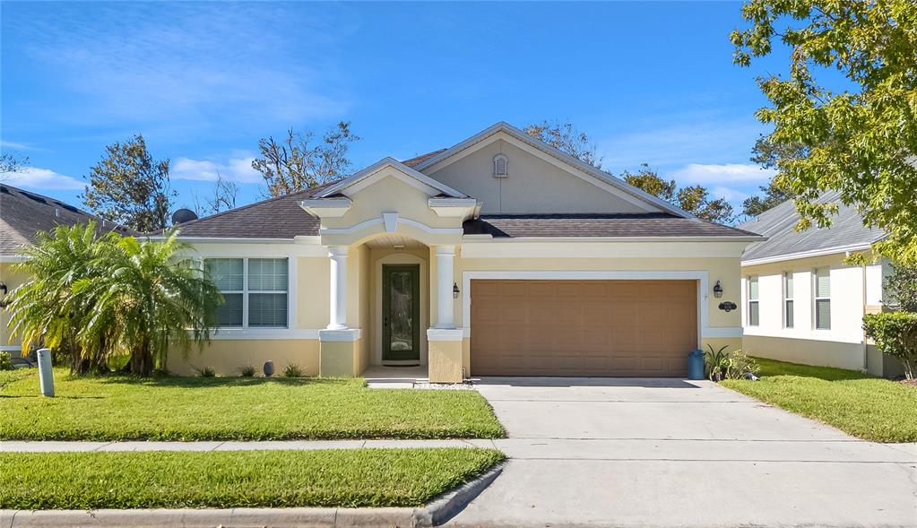 a front view of a house with a yard and garage