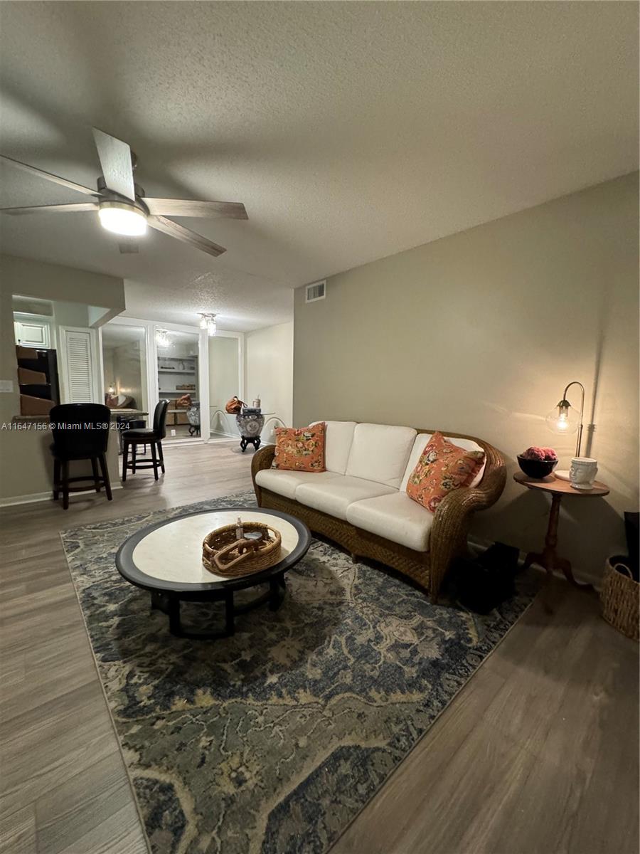 a living room with furniture and a dining table