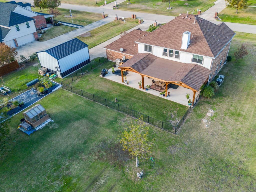 an aerial view of residential house with outdoor space and trees all around