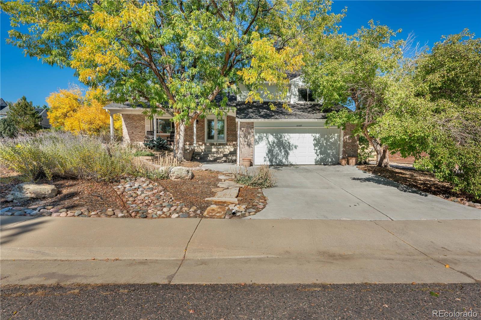 front view of a house with a tree