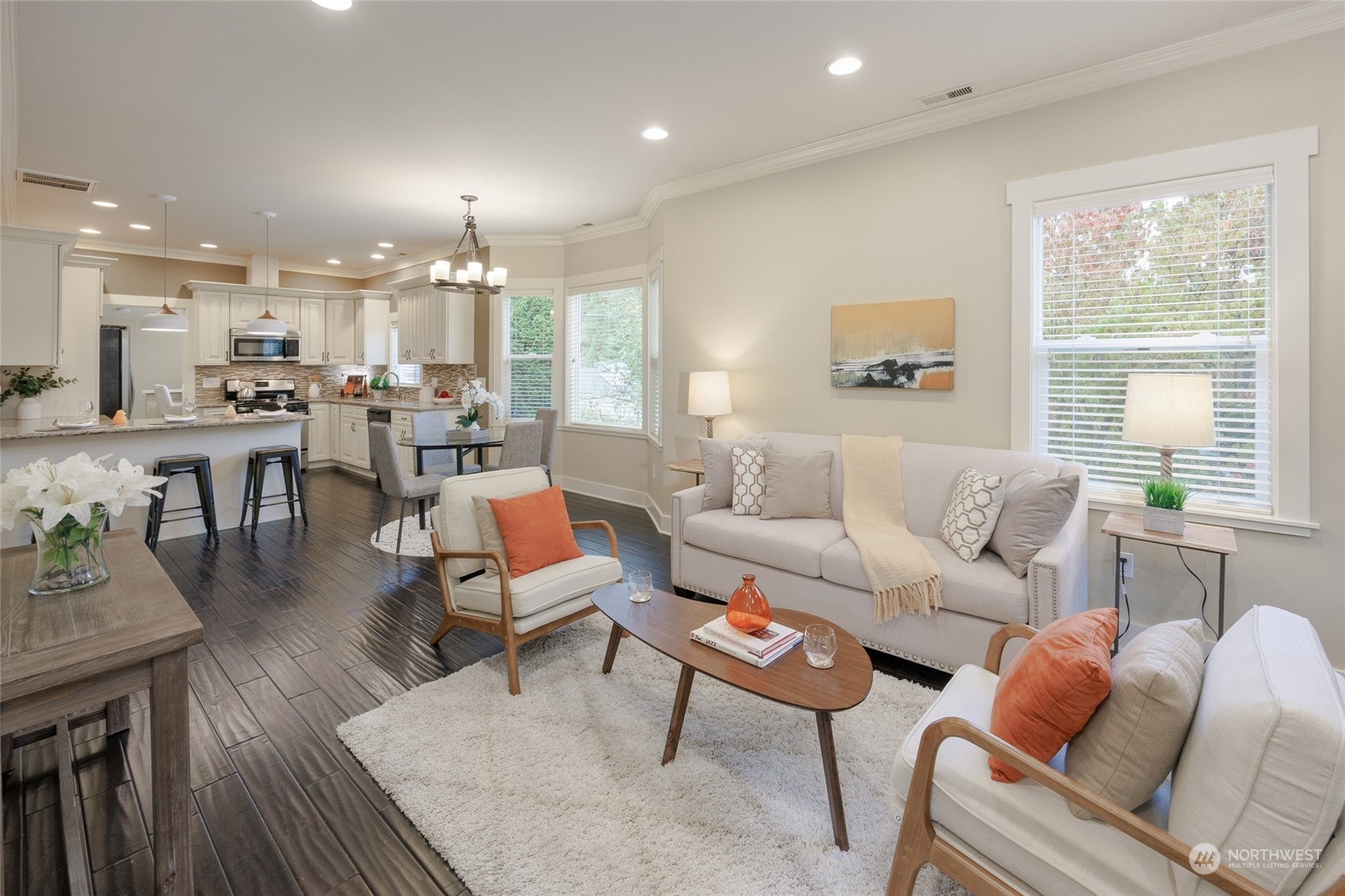 a living room with furniture dining table and a large window