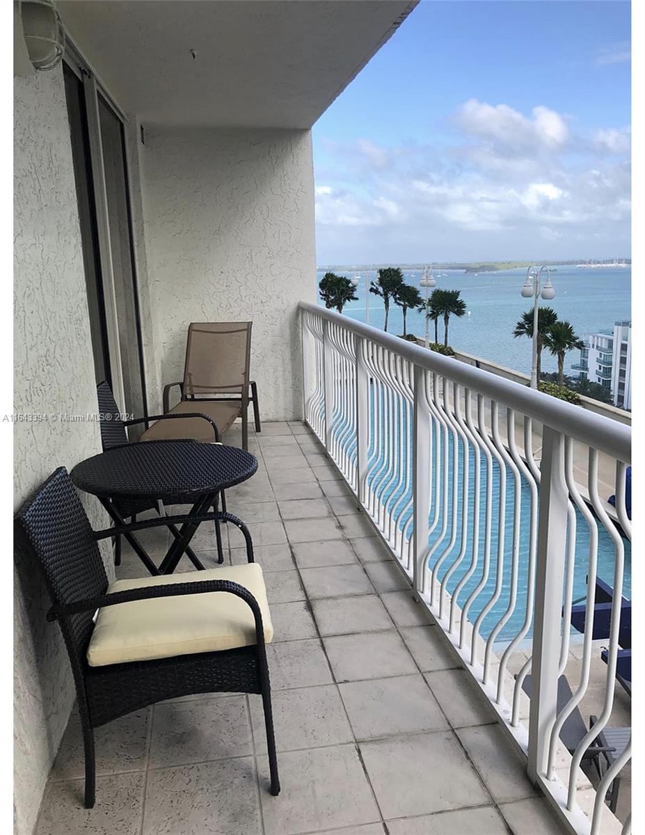 a view of a chairs and table in the balcony