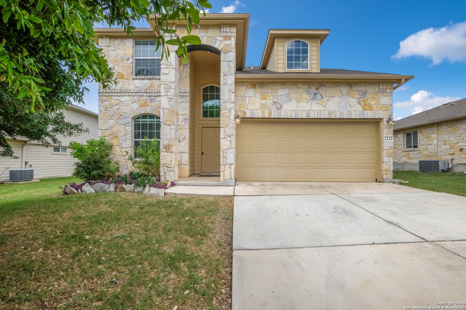 front view of a house with a yard