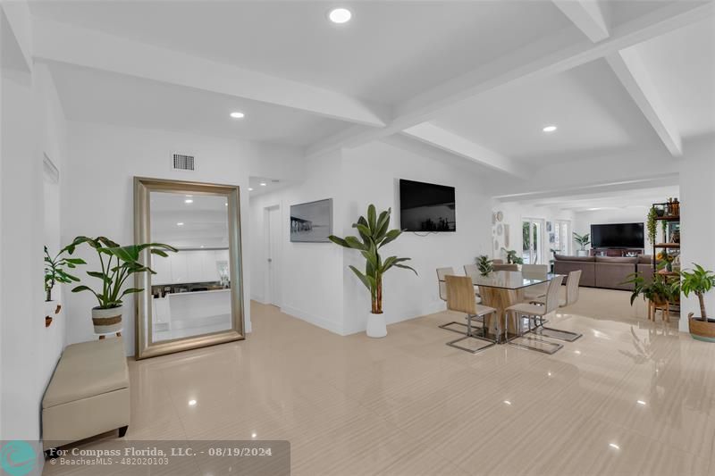 a living room with furniture potted plant and a flat screen tv