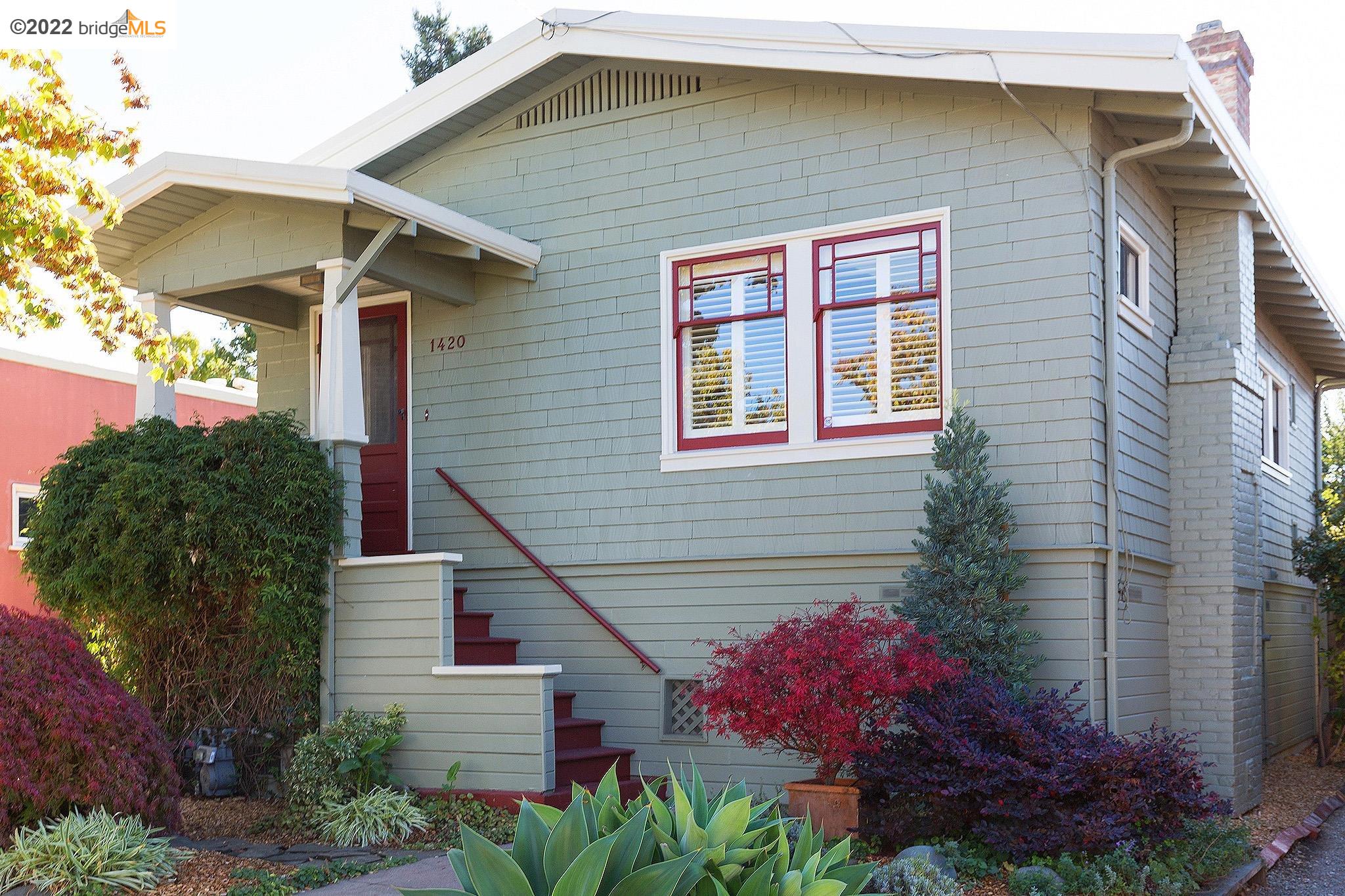 a front view of a house with plants