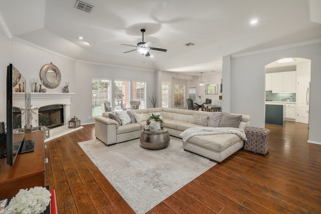 a living room with fireplace furniture and a wooden floor