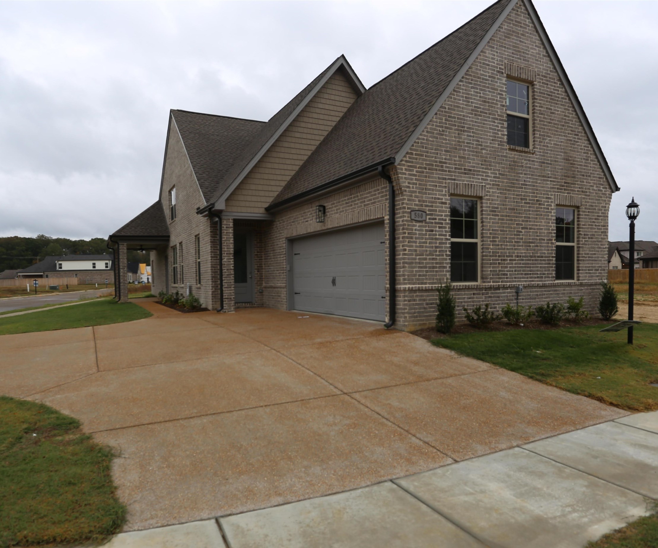 a view of garage yard and deck