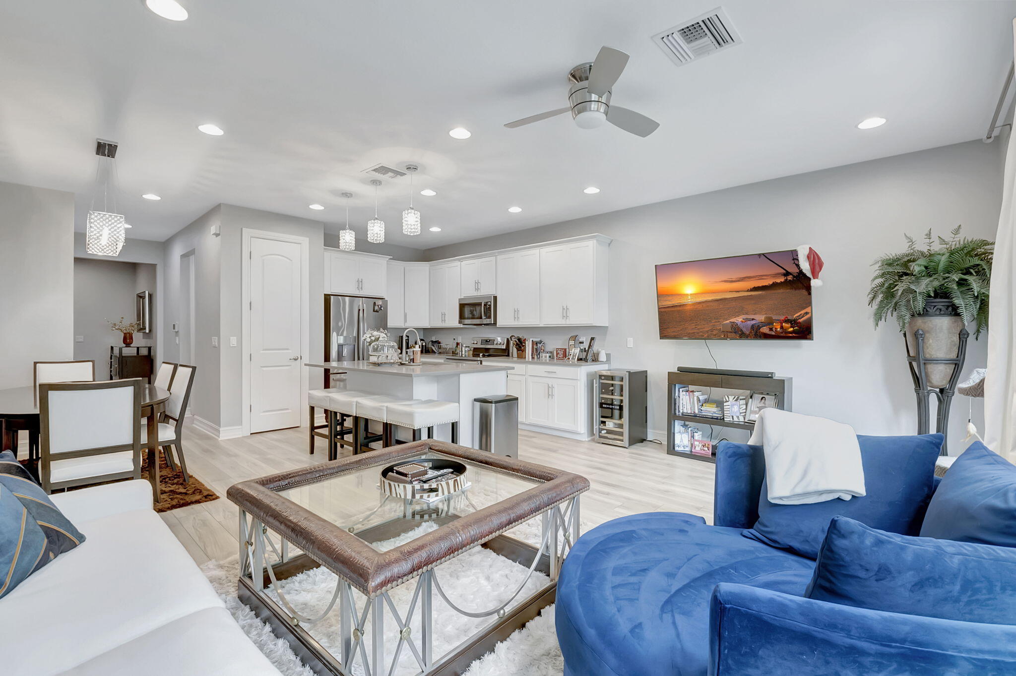 a living room with furniture kitchen view and a flat screen tv