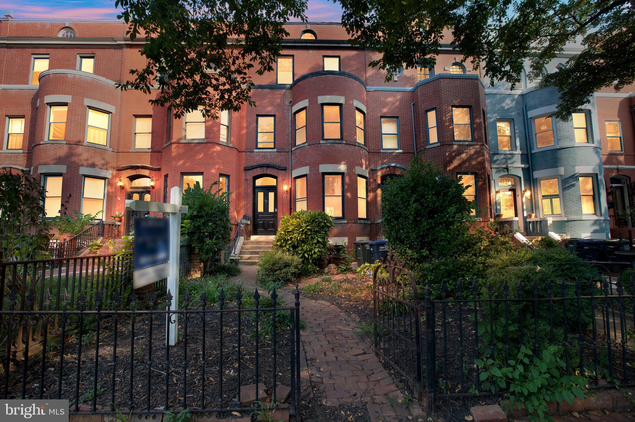 a front view of a residential apartment building with a yard