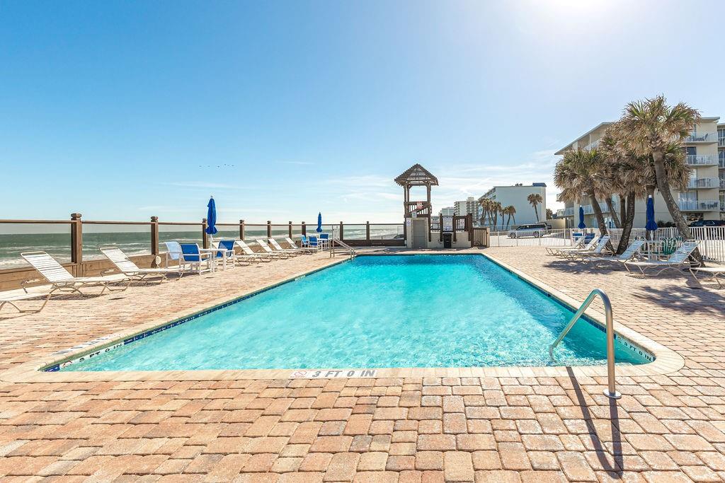 a view of a swimming pool with a lounge chairs