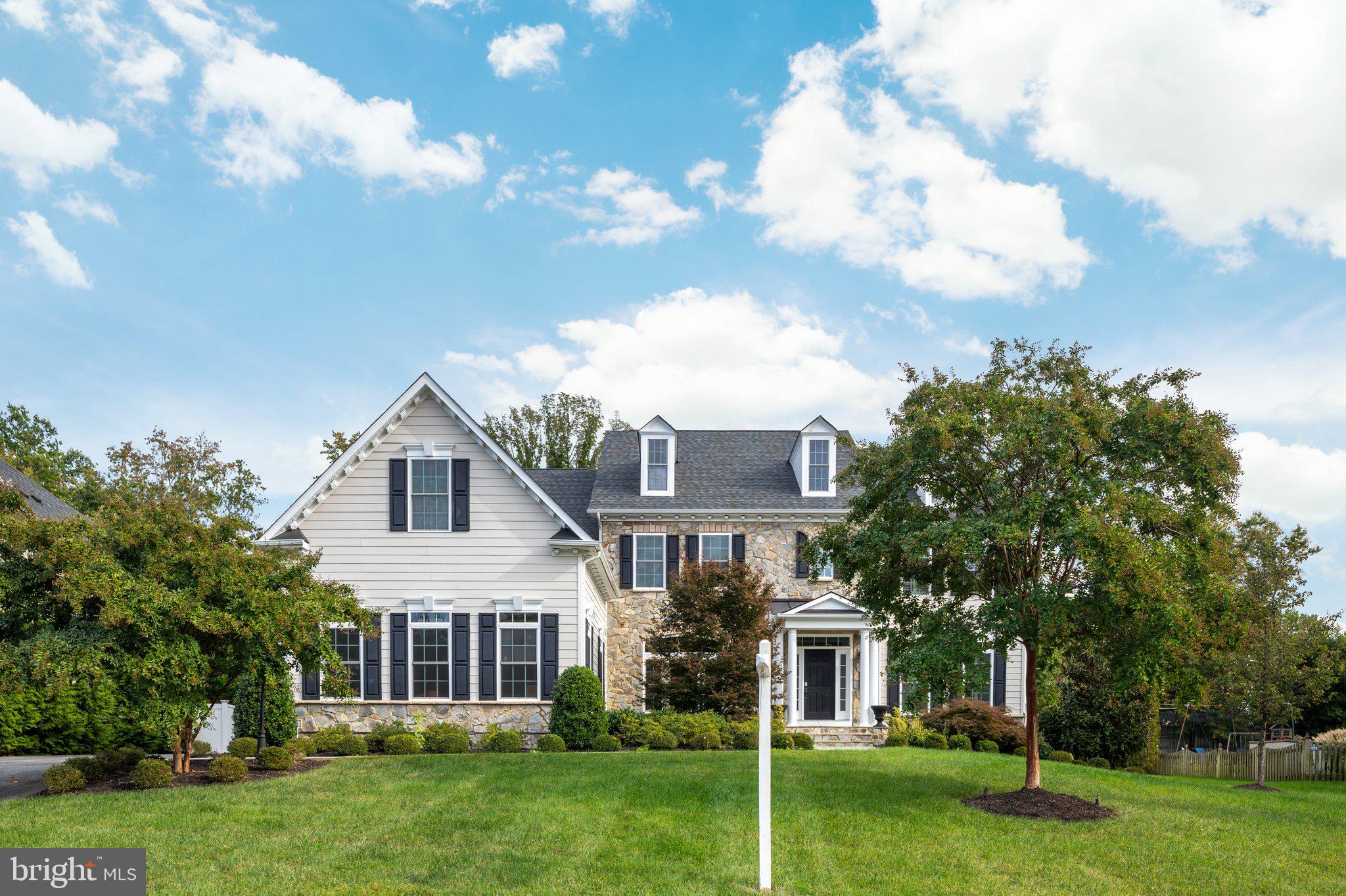 a front view of house with yard and green space