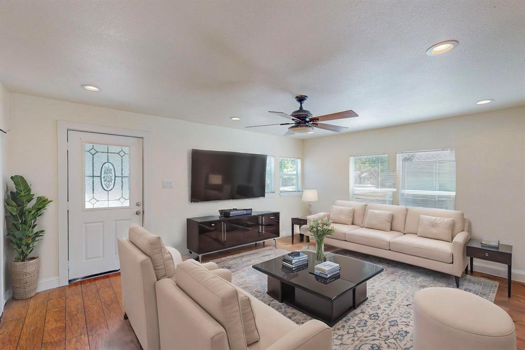 a living room with furniture a rug and a flat screen tv