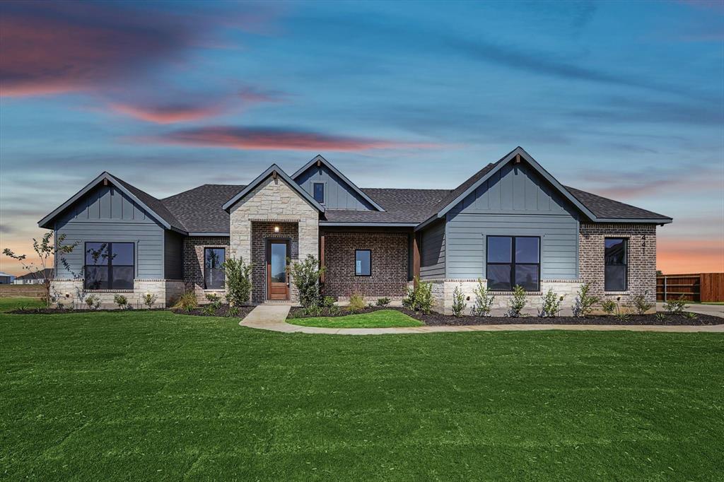 a front view of house with yard outdoor seating and green space