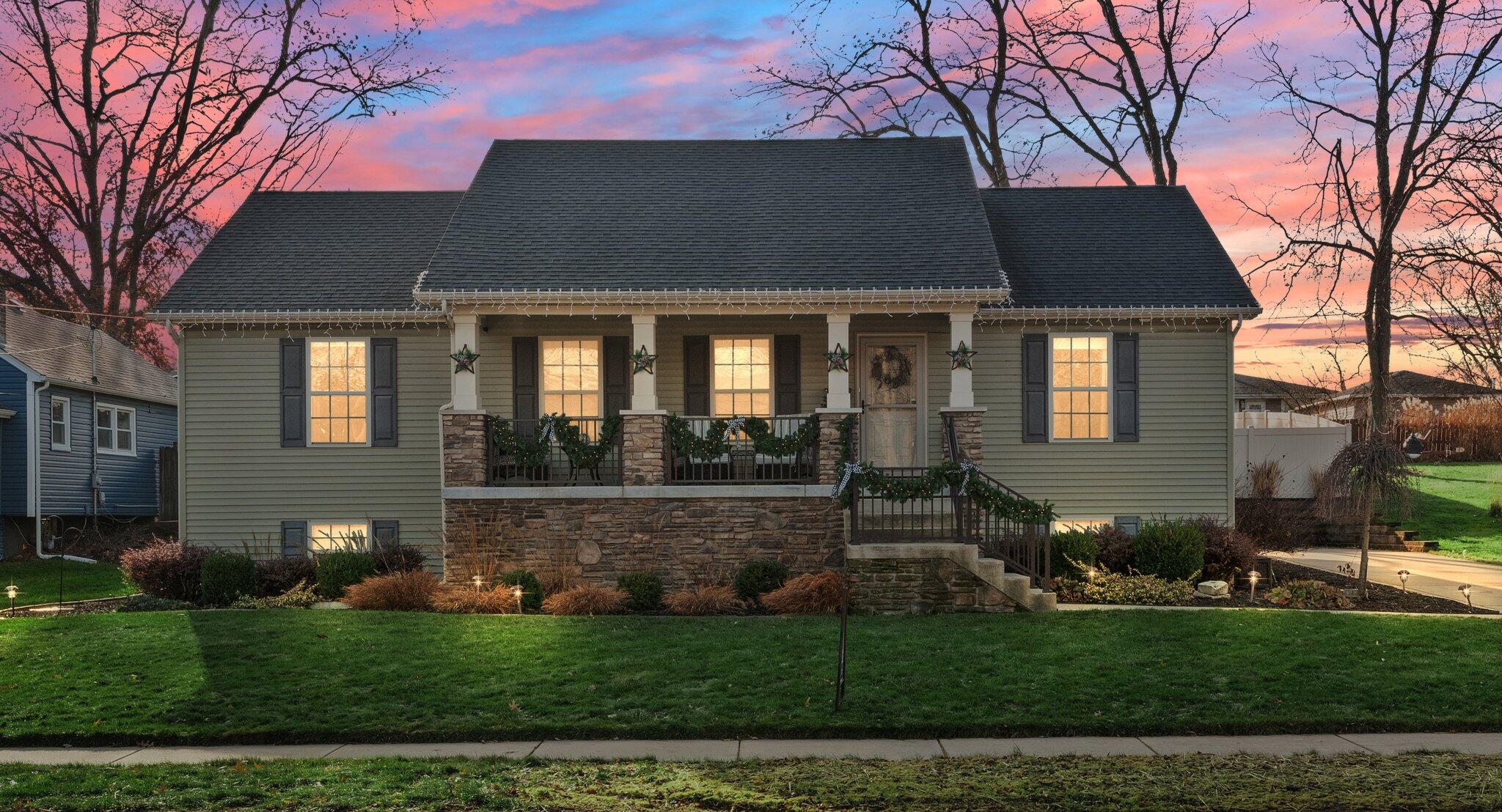 a front view of a house with a garden