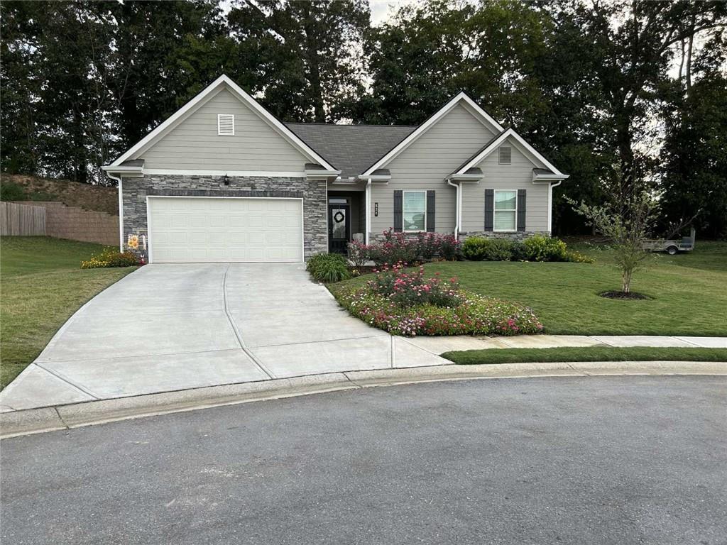 a view of white house with a yard and garage