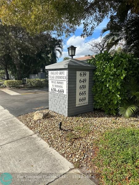 a front view of a house with a sign board