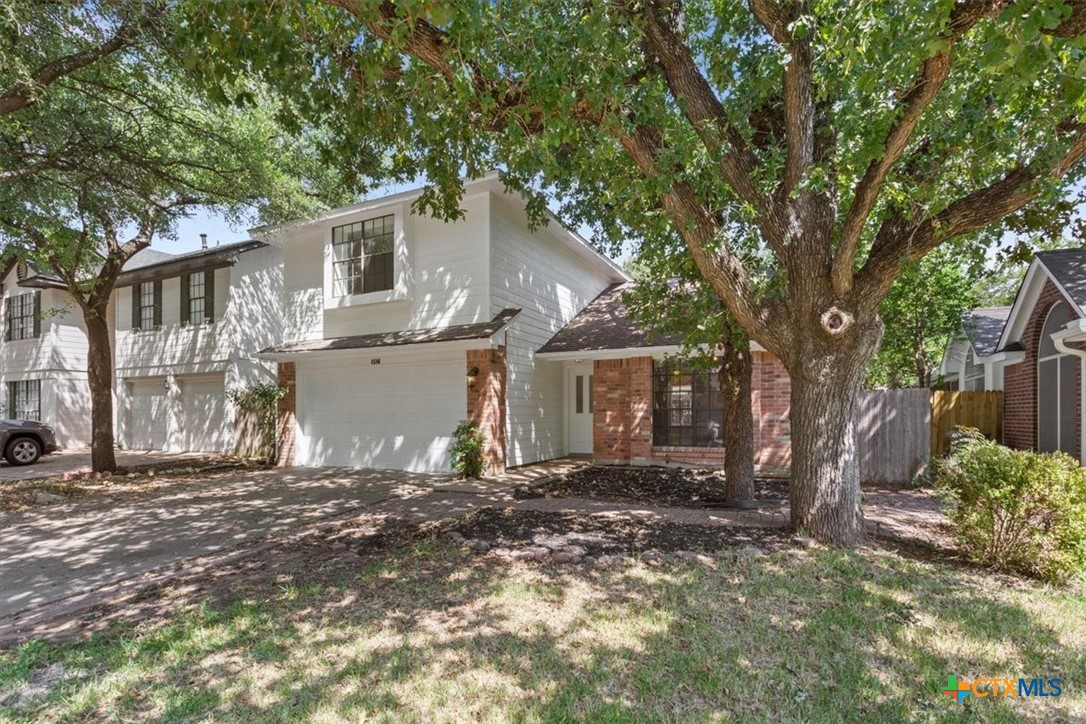 a view of a house with a tree in the background