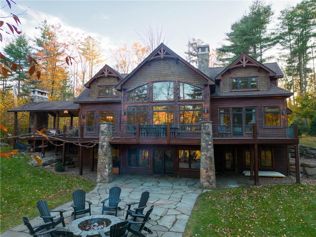 a view of house with a big yard and sitting area