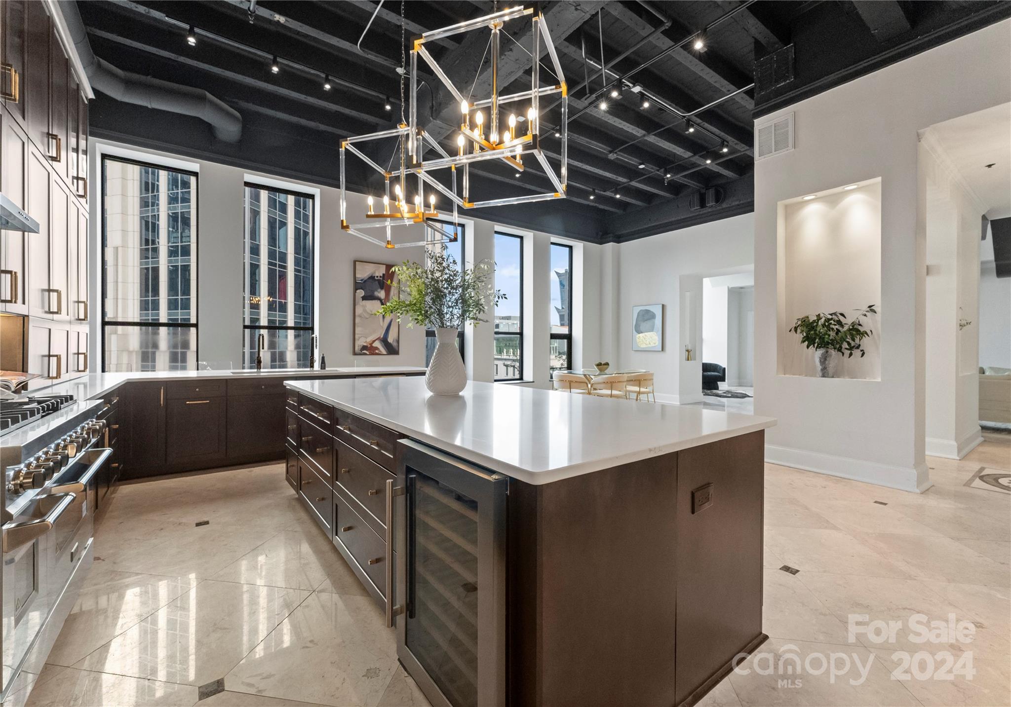 a kitchen with stainless steel appliances granite countertop a sink and a counter top space