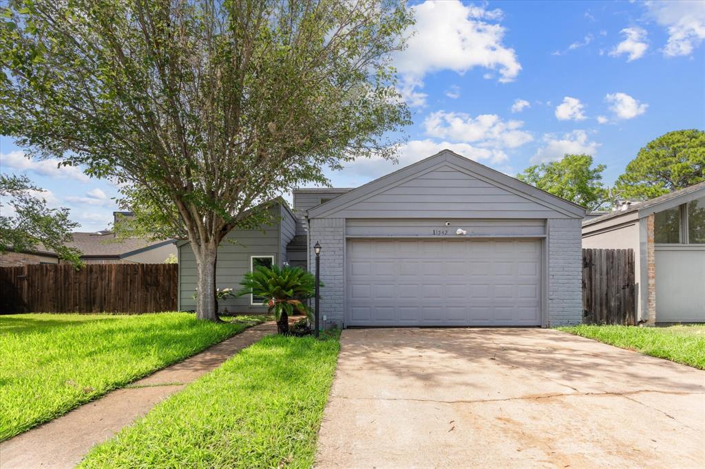 a front view of house with yard and garage