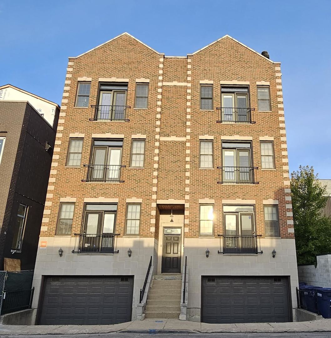 a front view of a residential apartment building with a yard