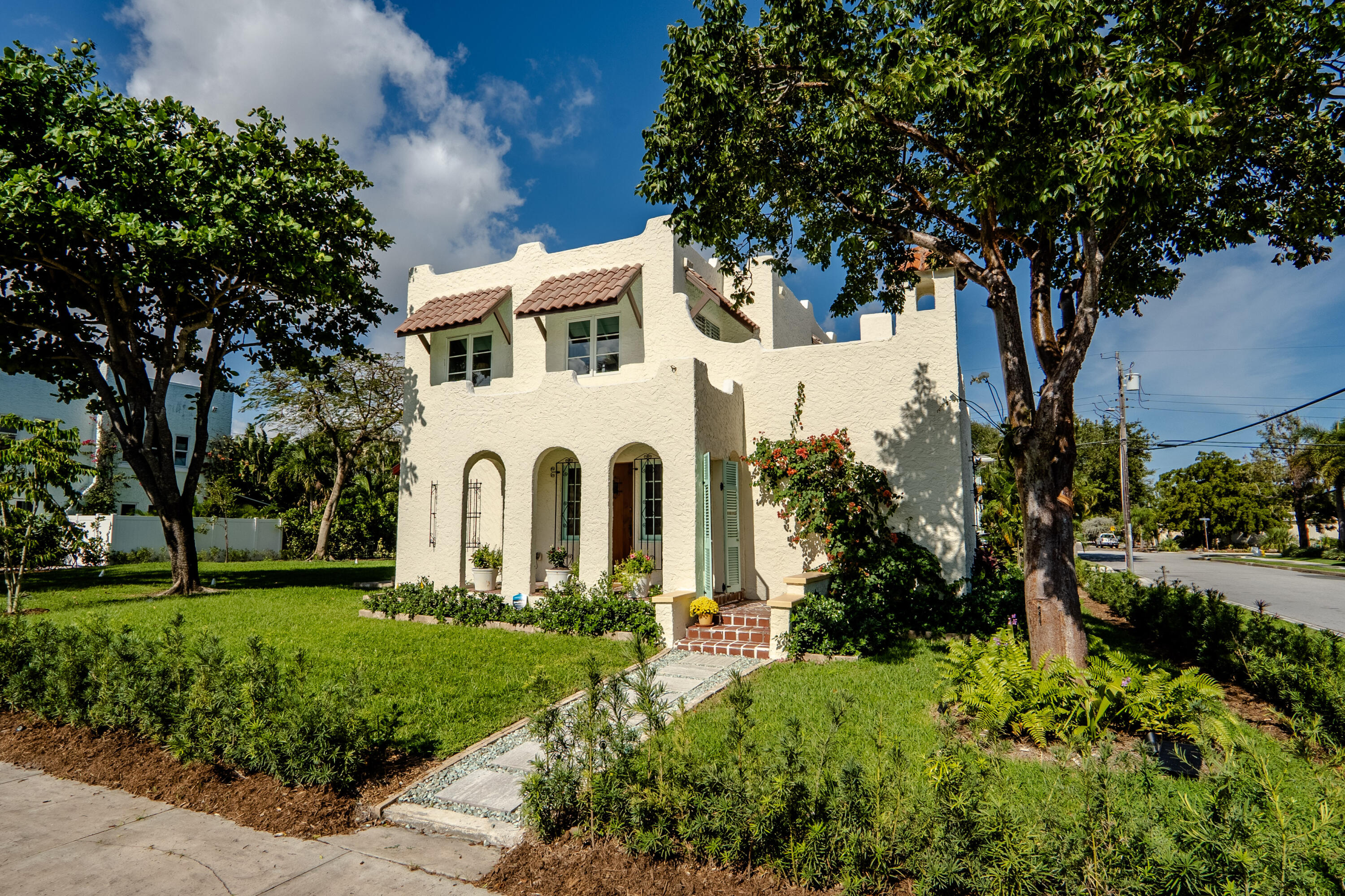 a front view of a house with garden