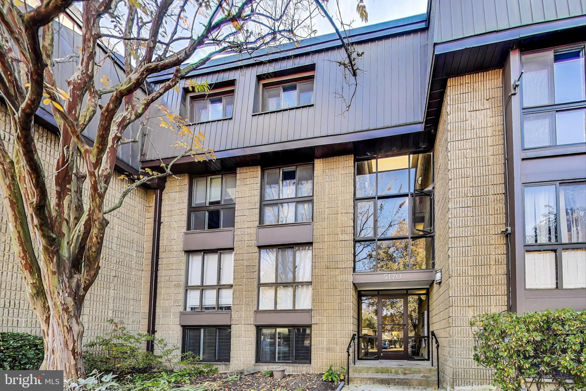 a front view of a residential apartment building with a glass door