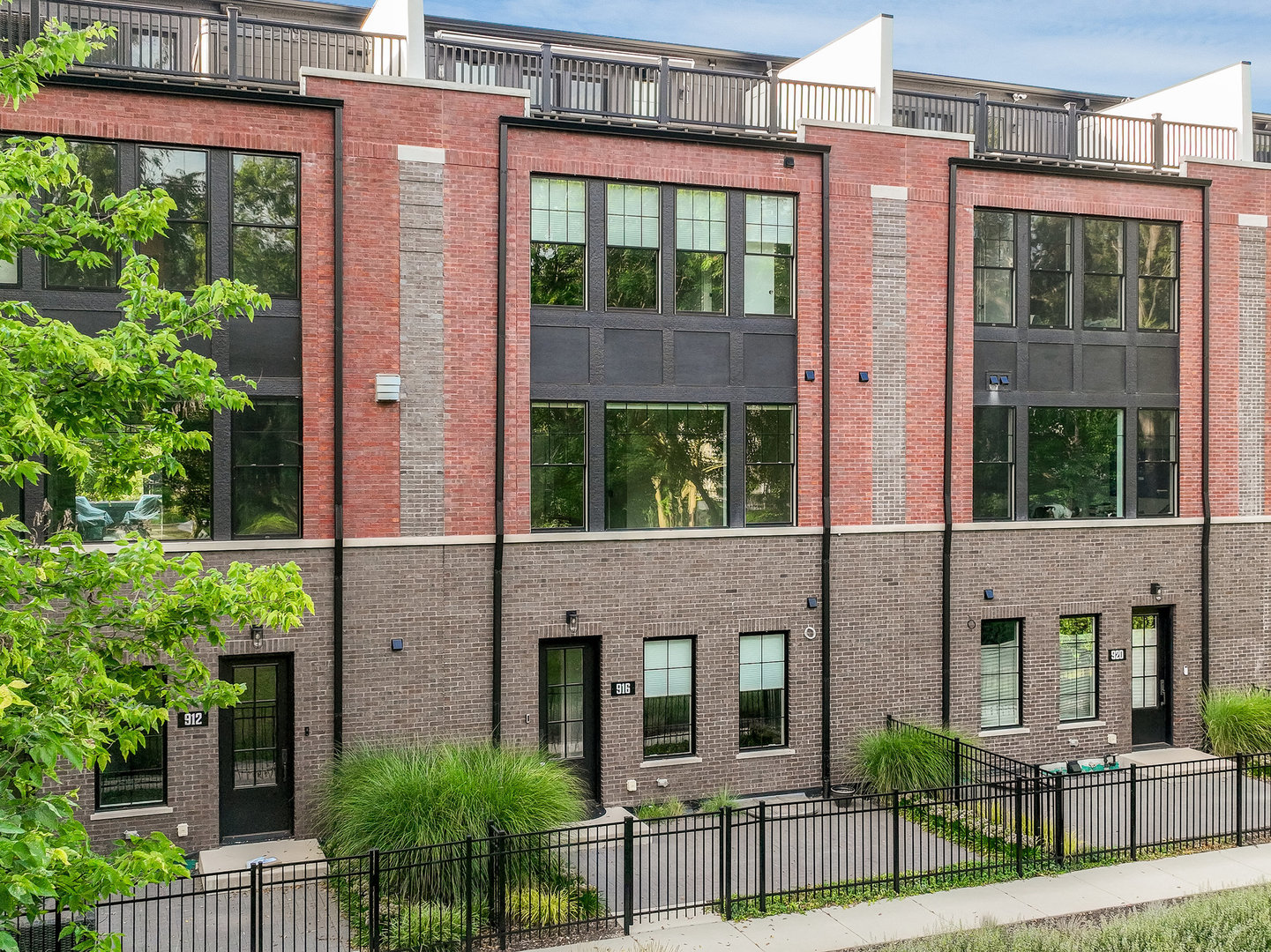 a view of a brick house with large windows