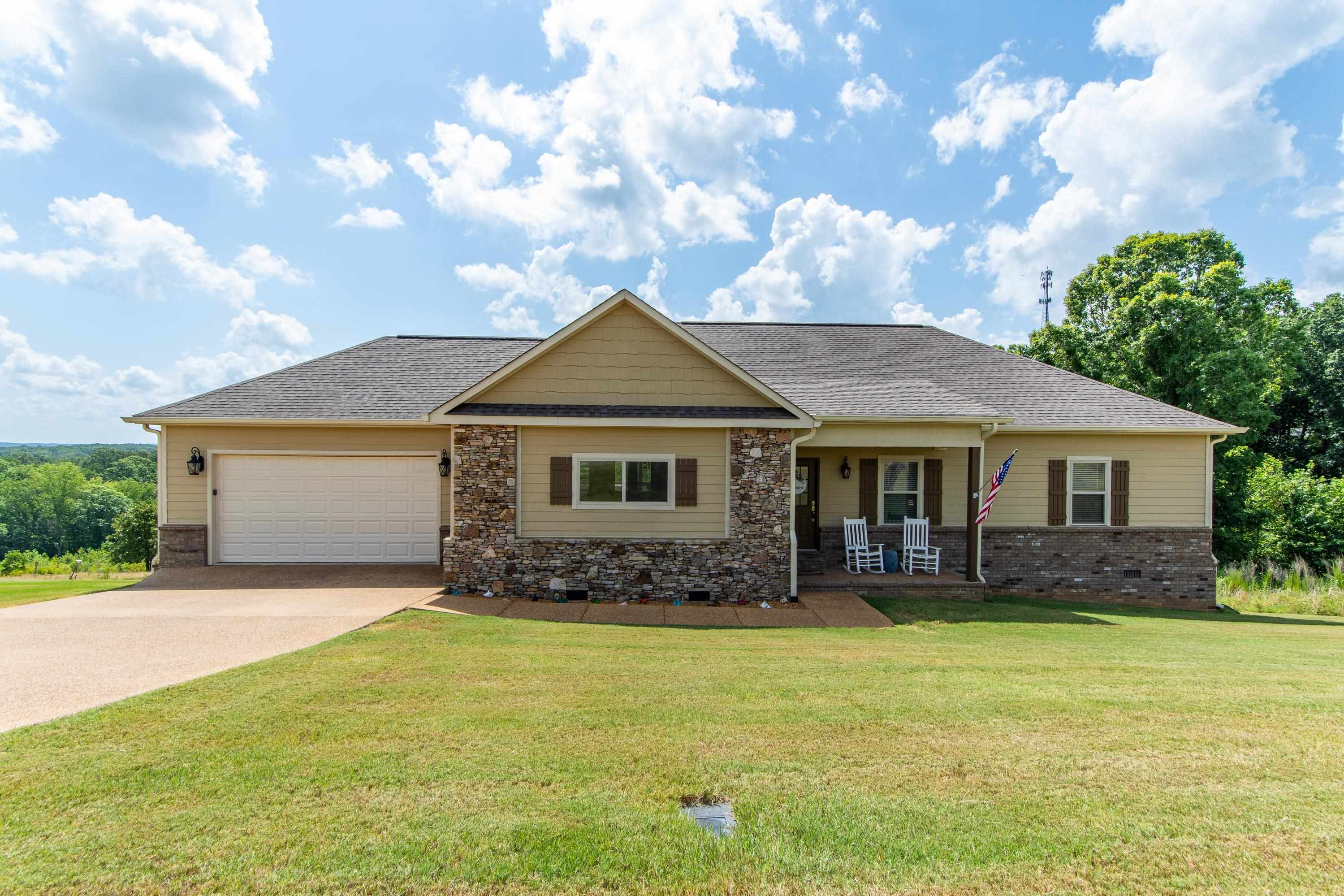 View of front of home featuring a garage and a front lawn