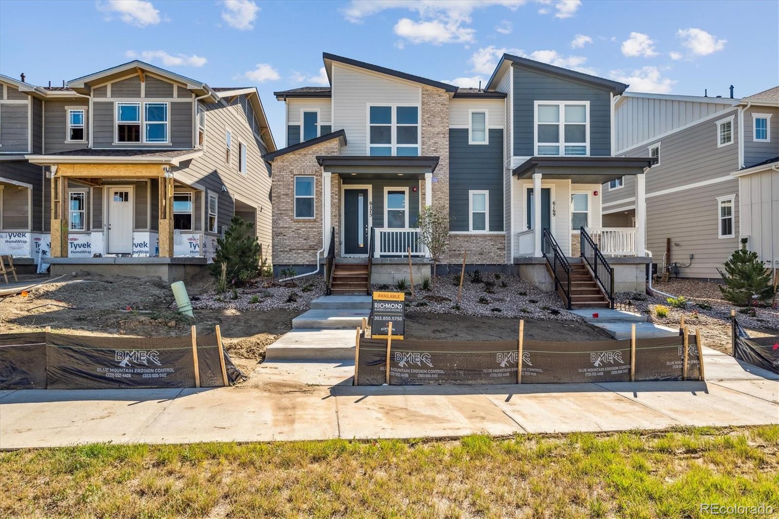 a front view of a residential apartment building with a yard