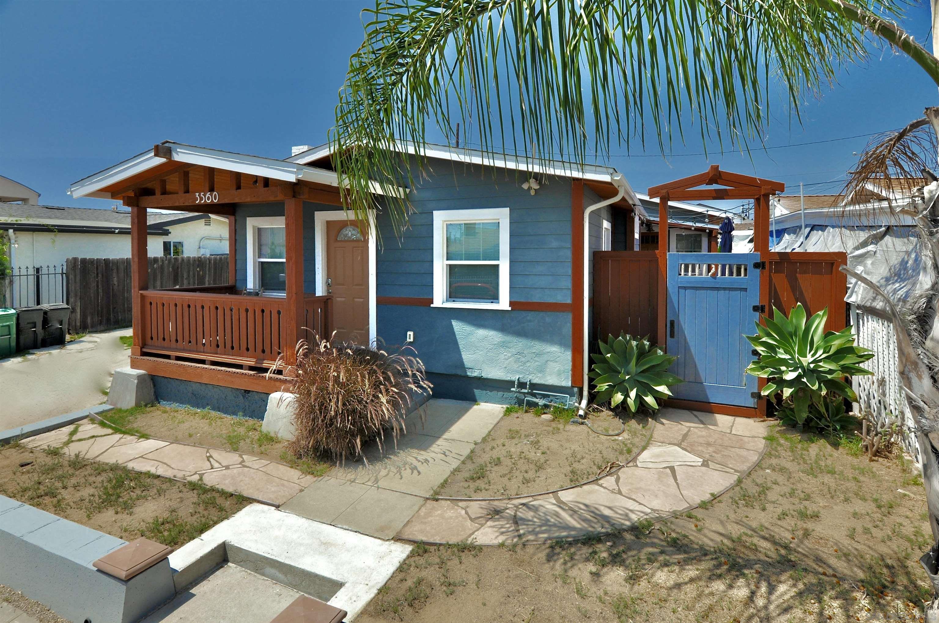 a front view of house with yard outdoor seating and barbeque oven