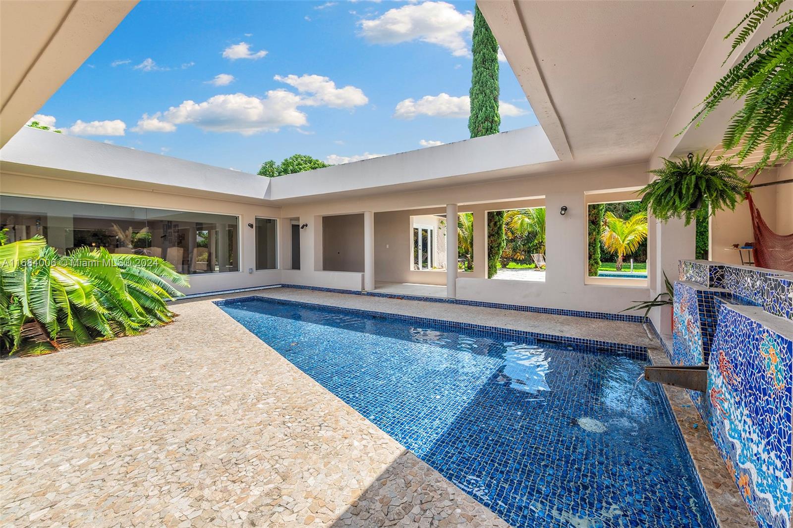 a view of a house with backyard and sitting area