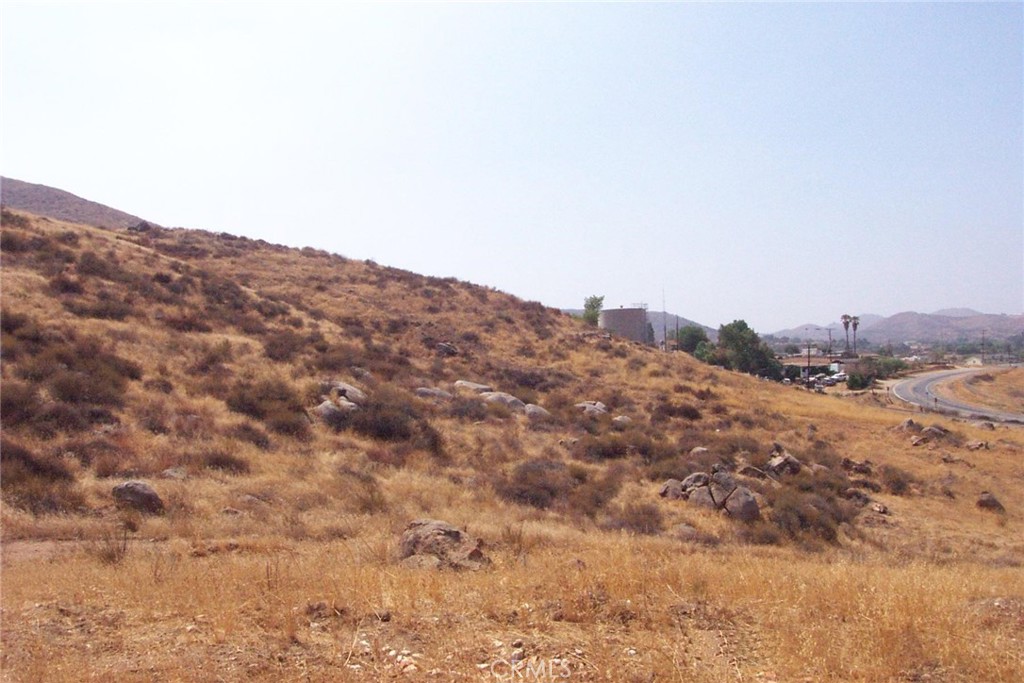 a view of a dry space with mountains in the background