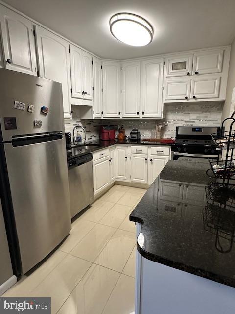 a kitchen with a sink a stove and cabinets