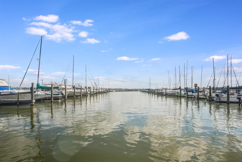 a view of a lake with boats next to a bridge