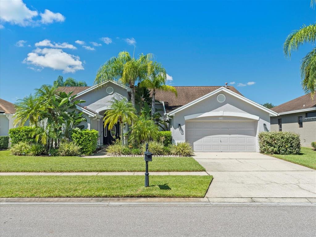 a front view of a house with a yard and garage