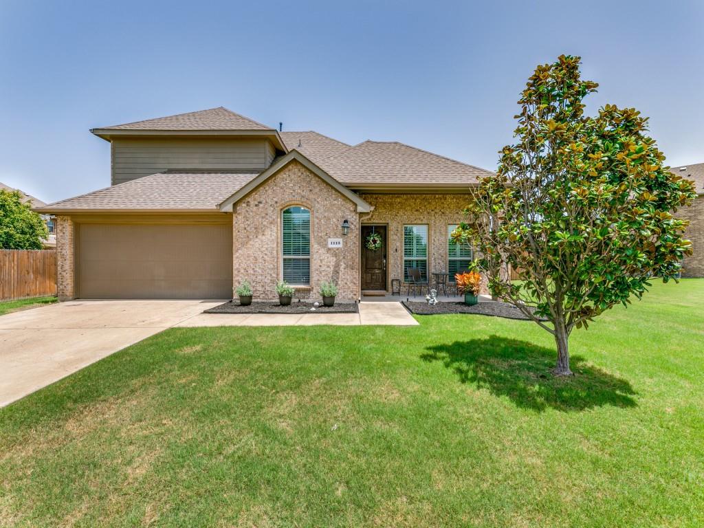 a front view of a house with yard patio and green space